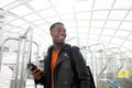 Young african american man smiling with cellphone at station Royalty Free Stock Photo