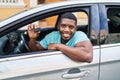 Young african american man smiling confident holding key of new car at street Royalty Free Stock Photo