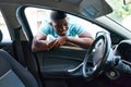 Young african american man smiling confident looking car leaning on door at street Royalty Free Stock Photo