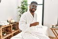 Young african american man smiling happy with facial mask drinking champagne at beauty center Royalty Free Stock Photo