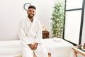 Young african american man smiling happy sitting on massage table at beauty center Royalty Free Stock Photo