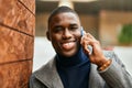 Young african american man smiling happy talking on the smartphone at the city Royalty Free Stock Photo