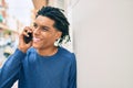 Young african american man smiling happy talking on the smartphone leaning on the wall Royalty Free Stock Photo