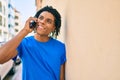 Young african american man smiling happy talking on the smartphone leaning on the wall Royalty Free Stock Photo