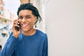 Young african american man smiling happy talking on the smartphone leaning on the wall Royalty Free Stock Photo