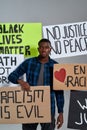 Young african american man standing in middle of banners
