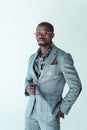 Young african american man in stylish suit and sunglasses, posing with hand in pocket, Royalty Free Stock Photo