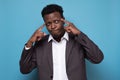 African american man in suit keeps fingers on temples, generating idea Royalty Free Stock Photo