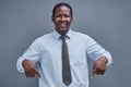 young african american man, surprised, points down with his hand Royalty Free Stock Photo