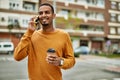 Young african american man talking on the smartphone drinking coffee at the city Royalty Free Stock Photo