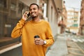 Young african american man talking on the smartphone drinking coffee at the city Royalty Free Stock Photo