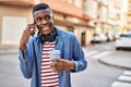 Young african american man talking on the smartphone drinking coffee at the city Royalty Free Stock Photo