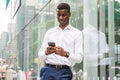 Young African American Man texting on cell phone, traveling in N Royalty Free Stock Photo