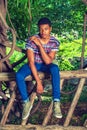 Young African American Man traveling, relaxing at Central Park, Royalty Free Stock Photo