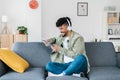 Young african american man using digital device relaxing on sofa at home Royalty Free Stock Photo