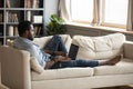 Young african american man using laptop lounge on sofa Royalty Free Stock Photo