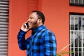 Young african american man walking and talking on mobile phone Royalty Free Stock Photo