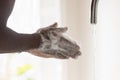 Young african american man washing hands with bubble antibacterial soap. Royalty Free Stock Photo