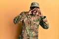 Young african american man wearing army uniform shouting angry out loud with hands over mouth Royalty Free Stock Photo