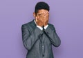 Young african american man wearing business clothes with sad expression covering face with hands while crying Royalty Free Stock Photo