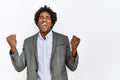 Young african american man wearing business jacket over isolated white background very happy and excited doing winner gesture with Royalty Free Stock Photo