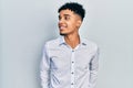 Young african american man wearing business shirt looking to side, relax profile pose with natural face and confident smile Royalty Free Stock Photo