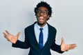 Young african american man wearing business suit crazy and mad shouting and yelling with aggressive expression and arms raised Royalty Free Stock Photo