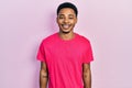 Young african american man wearing casua t shirt with a happy and cool smile on face