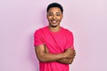 Young african american man wearing casua t shirt happy face smiling with crossed arms looking at the camera