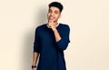 Young african american man wearing casual clothes looking confident at the camera smiling with crossed arms and hand raised on Royalty Free Stock Photo