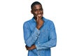 Young african american man wearing casual clothes looking confident at the camera smiling with crossed arms and hand raised on Royalty Free Stock Photo
