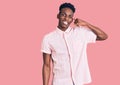 Young african american man wearing casual clothes smiling doing phone gesture with hand and fingers like talking on the telephone Royalty Free Stock Photo