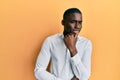 Young african american man wearing casual clothes smiling looking confident at the camera with crossed arms and hand on chin Royalty Free Stock Photo