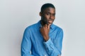 Young african american man wearing casual clothes smiling looking confident at the camera with crossed arms and hand on chin Royalty Free Stock Photo