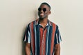 Young african american man wearing casual clothes and sunglasses with a happy and cool smile on face Royalty Free Stock Photo