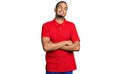 Young african american man wearing casual polo happy face smiling with crossed arms looking at the camera Royalty Free Stock Photo