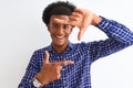 Young african american man wearing casual shirt standing over isolated white background smiling making frame with hands and Royalty Free Stock Photo