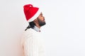 Young african american man wearing Christmas Santa hat over isolated white background looking to side, relax profile pose with Royalty Free Stock Photo