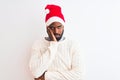 Young african american man wearing Christmas Santa hat over isolated white background thinking looking tired and bored with Royalty Free Stock Photo