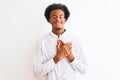 Young african american man wearing elegant shirt standing over isolated white background smiling with hands on chest with closed Royalty Free Stock Photo