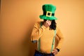 Young african american man wearing green hat celebrating saint patricks day tired rubbing nose and eyes feeling fatigue and Royalty Free Stock Photo