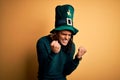 Young african american man wearing green hat with clover celebrating saint patricks day very happy and excited doing winner Royalty Free Stock Photo