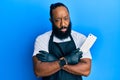 Young african american man wearing professional apron holding knife depressed and worry for distress, crying angry and afraid Royalty Free Stock Photo