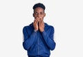 Young african american man wearing sportswear laughing and embarrassed giggle covering mouth with hands, gossip and scandal Royalty Free Stock Photo