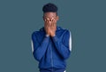 Young african american man wearing sportswear with sad expression covering face with hands while crying Royalty Free Stock Photo