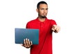 Young african american man working using computer laptop pointing with finger to the camera and to you, confident gesture looking Royalty Free Stock Photo