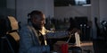 Young African-American IT manager, programmer or web developer closing his laptop in a dimly lit office. Concept of late Royalty Free Stock Photo