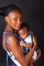 young african american mother carrying her baby in a sling Royalty Free Stock Photo