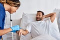 young african american nurse inserting catheter