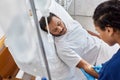 young african american nurse inserting catheter